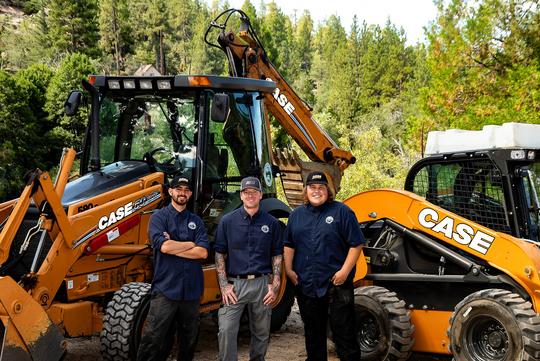 <img alt="picture of tim fernandez, jason weber, logan stinson standing in front of a backhoe and skidsteer" src="...">