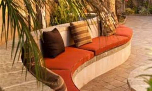 curved cement bench with terracotta custom cushions