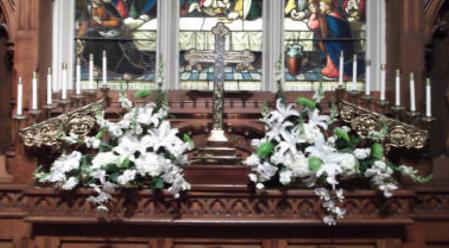 Both bookend altar arrangements done in whites and greens with orchids, fuji mums, casa blancas, hydrangea, and snapdragons