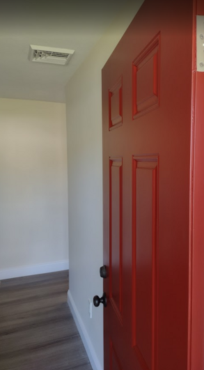 Exterior entry door painted red.
