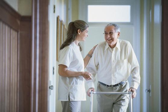 Elderly man walking using a walker