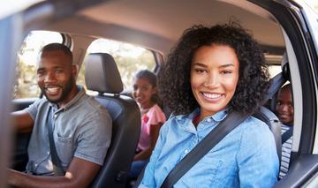 Happy Family in their insured family car