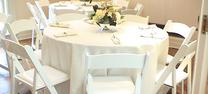 "Round table rental with white rental chairs for weddings and events