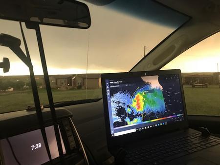 Radar technology on laptop in storm chasing van