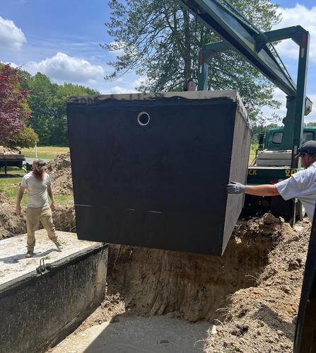 Massive black sceptic tank being place inground by SPEK Septics