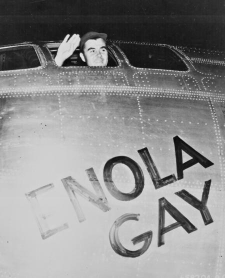 Col. Paul W. Tibbets, Jr., pilot of the ENOLA GAY, the plane that dropped the atomic bomb on Hiroshima, waves from his cockpit before the takeoff, 6 August 1945. 208-LU-13H-5.