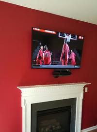 flat screen tv mounted over fireplace wiith floating glass shelf installed below.  TV installers, plasma tv mounting, 