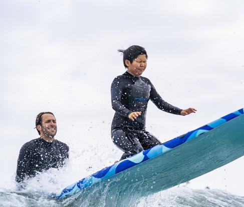 Blind Surfer Josh "the Jedi Loya teaching a surf lesson on the beach. Link to Waves4all Surf Page.