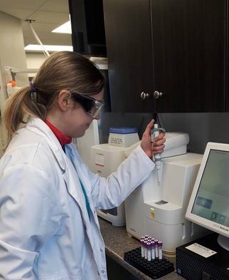 Dragon Lake Vet staff member running test on lab equipment