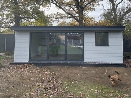Ash grey modern garden room with 3 panel bifold doors and small window