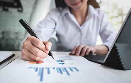 Lady holding a pen and report