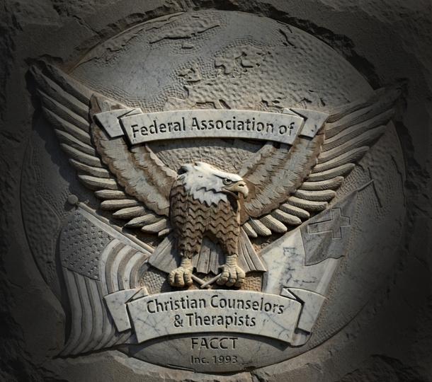 A stone engraving of the FACT emblem featuring an American Bald Eagle holding an American Flag and a Christian Flag with a banner at the top stating Federal Association of and a banner at the bottom stating Christian Counselors & Therapists. Under the bottom banner is FACCT 1993.