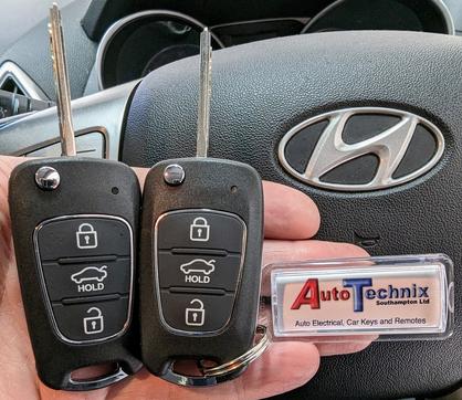 Two Hyundai remote flip keys and a key ring with Autotechnix written on it