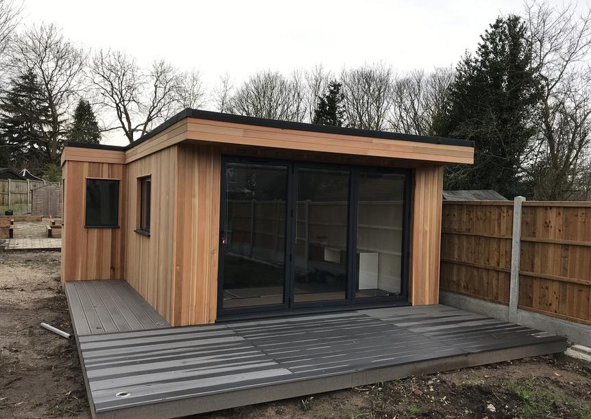 Modern cedar clad garden room with bifold doors and large deck, in Langdon Hills, Essex built by Robertson Garden Rooms