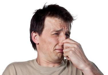 A man plugging his nose because of a terrible smell at a house in Tampa, FL.