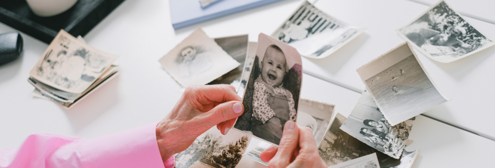 grandmother with picture taken decades ago - image is now digitized for archival storage on computer and USB