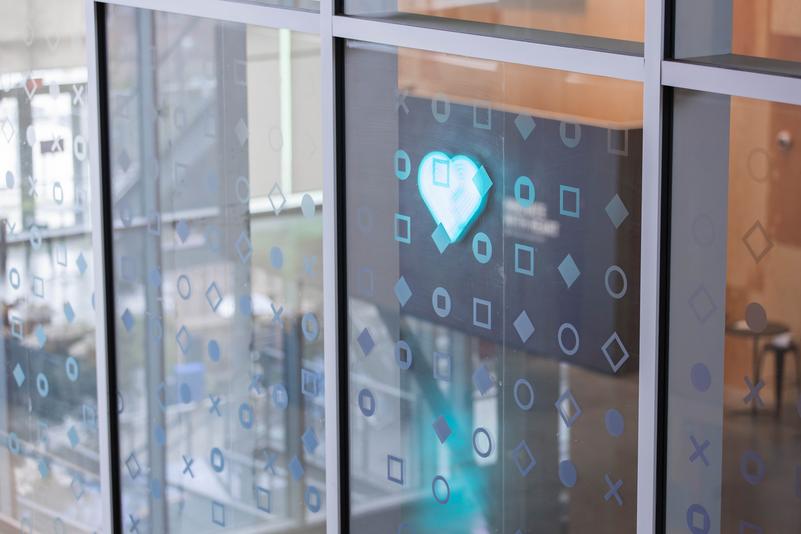 model holding wearable by big window with trees