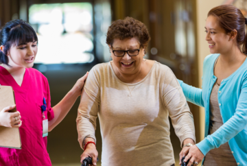 Featherstone Assisted Living nurse assisting tenant using walker