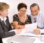Image of two females and one male reviewing a lease agreement.