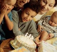 birthday boy getting ready to blow out his candles on a cake - important family memories captured in photos