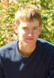 Jordan's senior picture, outdoors, smiling at camera