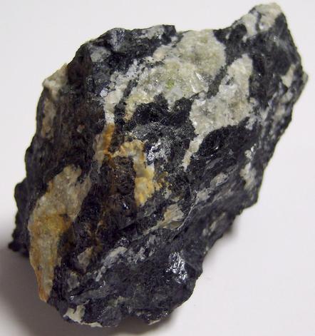 MAGNESIO-HORNBLENDE and fluorescent ALBITE, Philips Mine (Philips Pyrite Mine; Anthony's Nose Pyrrhotite Mine), Anthony's Nose, Philipstown Township, Putnam County, New York, USA
