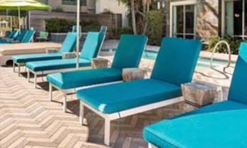 resort pool area with aqua colored Chaise lounge cushions