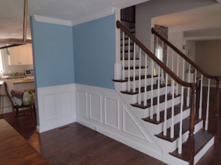 Painted staircase with wainscoting.