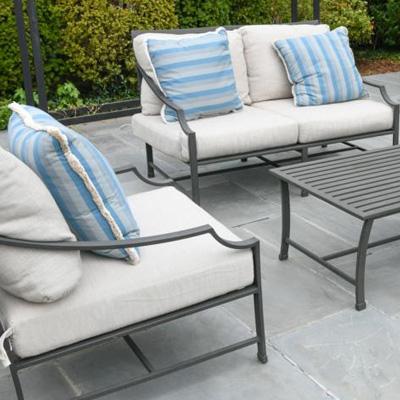 Restoration hardware outdoor furniture with white sunbrella cushions and blue toss pillows