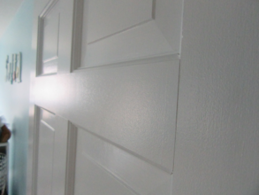 6-panel door painted a white semi-gloss.