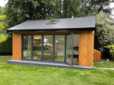 Modern cedar clad garden room with pitched roof, 5 panel bifold doors