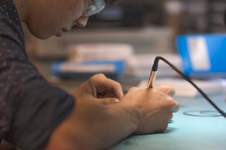 young man soldering