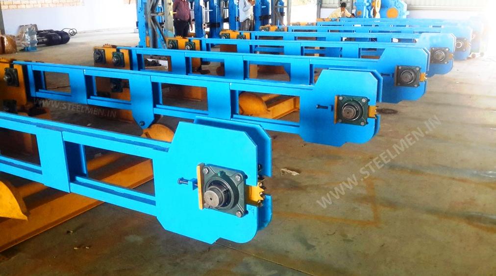 Y-TABLE FOR ROLLING MILLS, OIL LUBRICATION SYSTEM (Capacity - 50 LPM to 300 LPM), AUTOMATIC BUNDLING MACHINE, Hot Billet Shear, Billet Charging Grate, Flywheel, Gear Boxes, Mill Stands, Shearing Machines, Conveyor Rolls, Spindle Carrier, Pinch Rolls, Tilting Tables, Twin Channel, TMT Quenching System, Tail Breaker Pinch Rolls, Oil Lubrication System, Guide Box & Twist Pipes Mechanical Pusher, Mill Accessories, TMT Chain Transfer System, Recuperators, Cooling Tower, gear coupling, universal spindles, steel rolling mill, rolling mill items, steel plant machineries, steel plants, CCM, Continuous casting machine, steel melting, steel makers, leju Thomas, 9310524787, Gear boxes, Pinion stands, Rolling mill Stands on Fiber& bearings, Roller tables, Tilting tables, Y tables, Guide boxes, Chocks, Couplings, Spindles, Rotary shears, Flying shears, Cantilever type pinch Rolls, Tail Breaker pinch Rolls, Quenching Systems (for 8-16 mm, 16-25 mm, & 25-32 mm), Twin channel, Hot Rolling Mills, Shears, Automatic Cooling Bed, Quenching Boxes, Twin Channel Machine, Mill Stands, Cold Rolling Mills, Gear Couplings, Industrial Gear Box, Punching Cropping Machine, Hot Saw, Transmission Tower Machinery, Chain Transfer Systems, Product Design Development, Hot Rolling Mills Bar Rolling Mill Hot Rolling Mill Equipment Slit Rolling Mill Shears Flying Shear Crank Shear Continuous Rotating Shear Disc & Drum Shear Automatic Cooling Bed Quenching Boxes TMT Quenching Boxes Twin Channel Machine Industrial Gear Box Helical Gear Box Rolling Mill Gear Boxes Mill Stands Rolling Mill Stands TMT Mill Stands Housingless Mill Stands Cold Rolling Mills Gear Couplings Gear Jobwork Punching Cropping Machine Hot Saw Traveling type Hot Saw Fixed type Hot Saw Transmission Tower Machinery Chain Transfer Systems Product Design Development, Turnkey Solutions For Hot Rolling Mills Coilers Mill stands Shears & hot saws Twin channel Cooling beds Gear boxes & pinion stands TMT Equipment, Rolling Mill Machines Blade Grinding Machine Hot Saw Machines Straightening Machine Hydraulic Pusher, Hydraulic Cylinders, Ejectors, Hot Rolling Mill Flywheels Gear Boxes Mill Stands Gear Couplings Material Handling Equipment TMT Equipment Cooling Bed Shearing Machines Straightening Machines Spare Parts Of Rolling Mills Other Allied Equipments Bending & Time Machine Workshop Machinery, ♦ Bar Mills ♦ Structural Steel Mill Wire Rod Mill with Bar in Coil Line Rolling Mill for High-Grade Steels Section Mill High Speed Laying Head with Gear Box Crank Lever Shears Crank Shears Housingless Stands Double Crank Shears Rake Type Cooling Conventional Mill Stands Gear Boxes Rod mill block Varioblock Flying Shear • Tail Braking Pinch Roll • Cold Shear, Starting Stock Billets 160 x 160 x 12,000 mm 130 x 130 x 12,000 mm Furnace Group Charging grate, Hot charging, Elevator, Induction online heater Finished product Rebar 8 three-strand slit TMT Rebar 10 two-strand slit TMT Rebar 12-40 mm TMT Flats, angles and channels are possible too Sub-bundles 100-400 kg Master bundles 1 MT-3 MT Furnace Capacity 80 MT/h Main train Single-strand H/V arrangement, two strands are H/V type Roughing train : 4 off Model 600, 2 off Model 440, Free outlet after stand # 2 Intermediate train : 4 off Model 440, 4 off Model 340 Finishing train : 6 x Model 340 Associated shears Loopers : 8 off vertical, 6 off Single strand, 2 off multi strand Capacity 400,000 MT/y Cooling bed group Water quenching line, Thermex Cooling bed shear Cooling bed 66 x 10 m Finished speed 16 m/s (20 m/s) Material grades Carbon steels, Alloyed Structural Steel grades Continuous finishing shop Stationary cold shear 3,000 kN Counting system Small bundle forming 4 off Tying machine Various associated equipment, e.g. stoppers, chain transfers, roller tables, Starting stock Blooms 180 x 180 x 8,000 - 12,000 mm 300 x 300 x 8,000 - 12,000 mm Finished product Rebars 28 - 40 mm Rounds 30 - 100 mm dia. Hexagons 50 - 80 mm Flats 8 x 30 - 60 x 150 H-Beams 100 - 180 mm I-Beams 100 - 200 mm T-sections 75 - 140 mm Channels 100 - 200 mm Angles 80 x 80 x - 200 x 200 mm U-type sections for mine timbering 18U, 25U,29U Bundle/stack length 6 - 24 m Bundle/stack weight 2 - 5 t Furnace capacity 116/143 t/h Annual capacity 700,000 t/y Finishing speeds 6 m/s Material grades Carbon steels, Alloyed structural steel,Antifriction bearing steel Furnace group: Elevator (for hot charging), charging grate,weighscale, descaler, insulated holding tunnel Mill train: Single strand Roughing train 4 x Model 670, 1 x Model 760(V-H-HV-H) Intermediate train: 2 x Model 760, 4 x Model 670(H-H-H-UR-UR-HV) Finishing train: 5 x Model 670 (UR-HV-UR-HV-FUR) Associated shears Loopers: 4 x vertical Cooling bed group: Water cooling line, pinch roll unit Cooling bed shear Cooling bed 84 x 19 m Short-bar collecting device Continuous finishing shop In-line straightening machine (10 rollers) Hot saws: 1 x stationary, 1 x movable Abrasive cutting machines: 1 x fixed, 1 x movable Piling and stacking facilities (magnet-type) Tying machines: 2 x stationary, 2 x movable Various associated equipment, e.g. stoppers, chain transfers, roller tables. upto 150 x 150 x 12,000 mm Finished product: Wire rod 5.5 - 16 mm Rebars Nos. 3, 4 and 5 (as per ASTM) Coils 16 - 42 mm dia. Furnace capacity: 70 t/h Annual capacity: 300,000 t/y Finishing speeds: Wire rod line - 100 (120) m/s Bar in coil line - 13.5 m/s Material grades: Cold-heading steels Reinforcing steels Steels with a carbon content from low to medium Piano-wire PC-wire Free-cutting steel Water cooling line, pinch roll units, bar reels (2x), coil transfer,chain conveyor with retarded and accelerated cooling facilities, transfer unit to Power & Free coil handling system, Starting stock Billets 50 x 100 x 10,000 mm 125 x 125 x 11,400 mm Finished product Rod 5.5 - 13.5 mm dia. Bars 11 - 57 mm dia. Flads 22 - 120 mm, 5 - 12 mm thick Bundle/stack length 3 - 8.5 m Bundle/stack weight 0.5 - 3 (5) t Furnace capacity up to 60 t/h Material grades High-grade structural steels 34 Cr 4, 60 SiMn7, 42 CrMo4 Antifriction bearing steels 100 Cr 6, 100 Cr 2, 100 CrMo 7 3 Material grades Tool steels X 210 Cr 12, X 38 CrMoV 5 1, 55 CrNiMoVS 4 2 4 Acid-resistant and heat-resistant steels X 5 CrNiMo 18 11, X 2 CrNiMo 19 13,X 20 CrNiSi 25 4 High-speed steels X 79 Wco 18 5, X 82 W Mo 6 5 5 Special alloys X 55 CrMnNiN 20 8,X 45 CrSi 9 3 X 3 CrNiMoNbN 23 17 The complete range of steel grades includes approx. 300 different grades Furnace group: Charging grate, cross transfers, weighscale, descaler (2x), heatholding tunnel Mill train: Single strand, H/V - arrangement Roughing train: PSW and 6 x Model 440 Intermediate train: 4 x Model 440, 2 x Model 340 Finishing train: 4 x Model 340 Kocks-block 8-stand wire rod block for high grade steels 3 x 215/ 5 x 170 Associated shears Loopers: 7 x vertical, 1 x horizontal Cooling bed group: Water cooling line, pinch roll unit Cooling bed shear Cooling bed 57 x 5 m Continuous finishing shop: Abrasive cutting machine Piling and stacking facilities (non-magnet type) Tying machines: 1 x fi xed, 1 x movable various associated equipment, e.g. stoppers, chain transfers, roller tables etc. Rod finishing equipment: Water cooling and equalizing sections, pinch roll unit,laying head Ring conveyor for retarded and accelerated cooling reforming tub Pallet-type coil handling system, compacting & tying units,weighscale, unloading station Reel plant Water cooling and equalizing sections, Pinch roll units, Bar reels: 2 x, Transfer equipment to pallet-type coil handling system, Omsairam Steel & Alloys Pvt. Ltd., Bhagyalaxml Rolling Mills Pvt. Ltd., Kalika Re-rollers Pvt. Ltd., Parvati Alloys (P) Ltd., MITC Rolling Mills (P) Ltd., Maharashtra Steel Rolling & Engg Co. Chimanlal Vijay Kumar Steels Pvt. Ltd, Bhagwati Ferro Metals (P) Ltd, Balbir Rolling Mills Ltd. Quartz Metals Inds., Metro Alloys Ltd., Pushpak Steel Inds. Pvt Ltd., T. k. Ispat Pvt Ltd., Allied Ferromelt Pvt Ltd., Bhagwati Steel Cast Ltd., R. L. Steels Ltd., Guardian Steels Pvt. Ltd., Shri Karvir Nivasini Mahalakshmi Ispat Pvt. Ltd., Khatu Shyamji Steel Rolling Mills Pvt. Ltd., Kunal Ispat & Alloy Inds. Pvt Ltd. Sun Metallics & Alloys Pvt. Ltd, Hans Ispat Ltd. Shri Khatu Shyam Industries, Rajuri Steel Pvt. Ltd, Shree Om Steel Rolling, Air Carrying Corpn (I) Ltd., titan Alloys Ltd. Sunflag Iron & Steel Co. Ltd., Sharda Ispat Ltd., Fortune Metaliks Ltd., Sharda Shree Ispat Ltd., R. K. Structures Pvt. Ltd., Sanvijay Industries Pvt. Ltd., Shivali Udyog (I) Ltd., S.D. Bansal Iron & Steel Pvt. Ltd., Inertia Iron & Steel Inds. Pvt. Ltd., Nalwa Steel & Power Ltd., Shilpa Re-rollers Ltd., Sri Jai Balaj Steel Rolling Mills Ltd., Petropol India Ltd. Galwalia Ispat Udyog Pvt. Ltd. Crest Steel & Power Pvt. Ltd. Himalayan Rolling Steel Industries Pvt. Ltd., Shree Balaji Pigments Pvt. Ltd., Upper India Steel Mfg. & Engg. Co. Ltd., Capital Ispat Ltd., Barnala Steels Inds. Ltd., Shri S.S. Shyam Steels Pvt. Ltd. Fortune Metals Ltd. Rathi Udyog Ltd., M/s. Gallantt Ispat Lyd., Gemini Merchandise Pvt. Ltd., Jagdamba Rolling Mills, Shree Krishna Steel Rolling (Jaipur) Ltd. Modi Steels, Usha Martin Inds. Prince TMT Steels Pvt. Ltd., Dindigul Iron & Steel Co (P) Ltd. ARS Metals Ltd. V.V. Iron & Steel Company Pvt Ltd. Jairaj Ispat Ltd., Pioneer Torsteel Mills (P) Ltd., Devshree Ispat Pvt. Ltd., Vaibhav Merchantile Ltd., Maa Mahamaya Inds. Pvt. Ltd., Chitrakoot Metal Ltd. P. R. Rolling Mills Pvt. Ltd. Shree Aravindh Steels Ltd. Shyam Steel Industries Ltd. Shri Ramrupai Balaji Steels Ltd. Adhunik Ispat Pvt. Ltd. Durgapur Steels Ltd. B. M. A. Stainless Ltd. Zion Steel Ltd. Shree Metaliks Ltd. Usha Martin Ltd. Shyam Sel Ltd. Maithan Steel & Power Ltd.