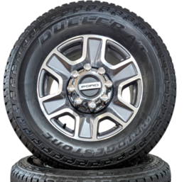 FORD 8 LUG 18" F-250 / F-350 BRIGHT MACHINED AND CARBONIZED GRAY WHEELS WITH BRIDGESTONE DUELER A/T