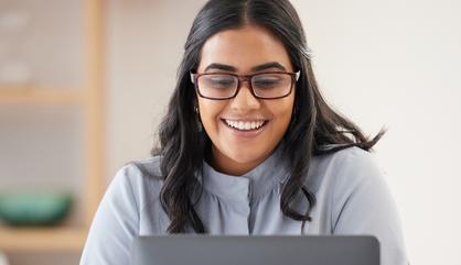 Business person at an office looking at a laptop