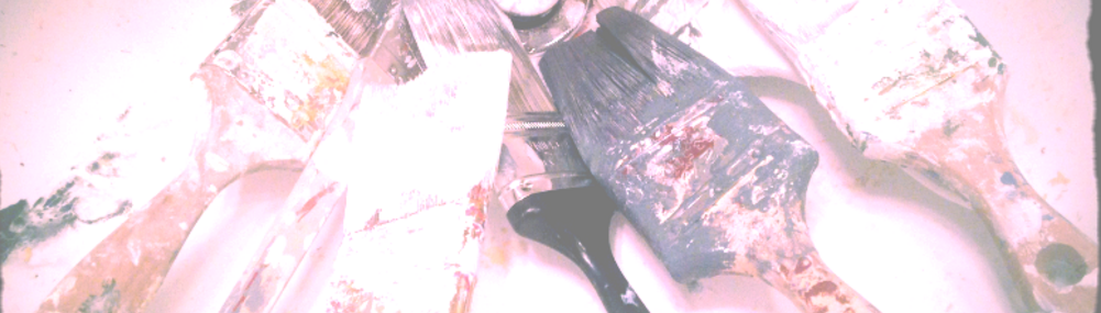 A banner background photo of several paint-covered brushes lying side by side in a sink, ready to be washed-- A typical scene after a solid painting project.
