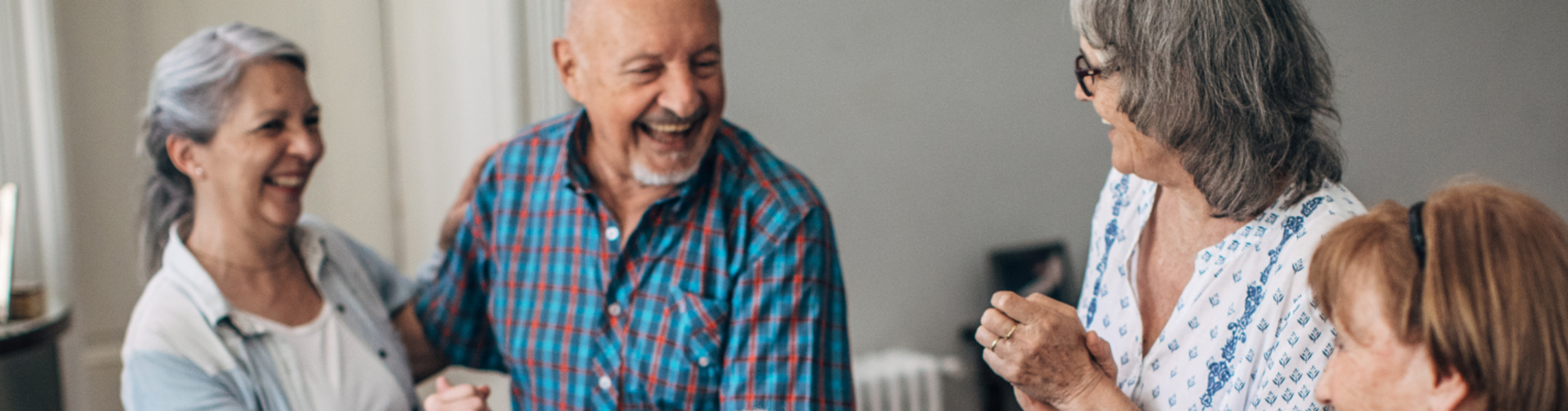 Elderly family laughing and enjoying visiting hours at assisted living