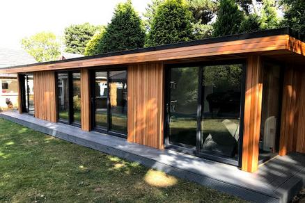 Large modern cedar clad garden room with 3 sets of double full length windows