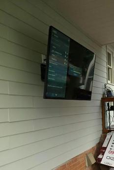 flat screen plasma lcd tv mounted with full motion mount on outdoor deck in charlotte nc, 