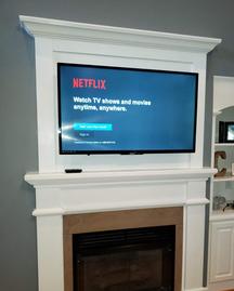 Custom Fireplace Cover up, TV mounted over fireplace niche by Carolina Custom Mounts in Charlotte and Fort Mill SC