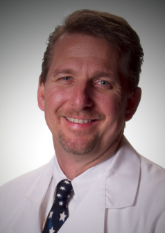 Head shot of Dr. Ottomeyer smiling in lab coat