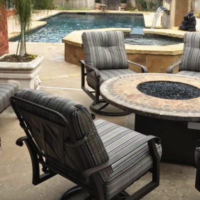 woodard patio furniture with new patio cushions in black, grey, and brown striped fabric