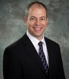 Dr. Hadden headshot in tie and coat