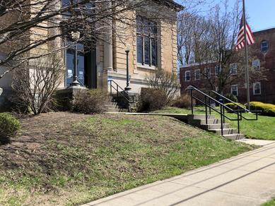 Overgrown and untended western lawn of Johnstown Public Library