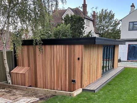 Cedar clad garden building with dark grey 5 panel bifold doors
