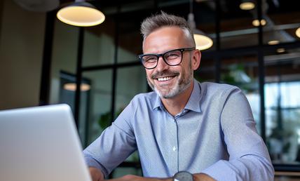 Business person working at an office desk with a laptop