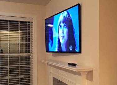 Flat Screen, LCD, Plasma, 4k ultra, and curved TVs mounted over fireplace with wires hidden. Installed by Carolina Custom Mounts in Charlotte NC