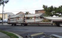 picture of a truckload of new boats for sale