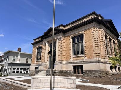Library building, flagpole, and graded lawn