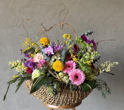 Hand-tied bridal bouquet with white ranunculus, brunia, billy balls, succulents, and other elements